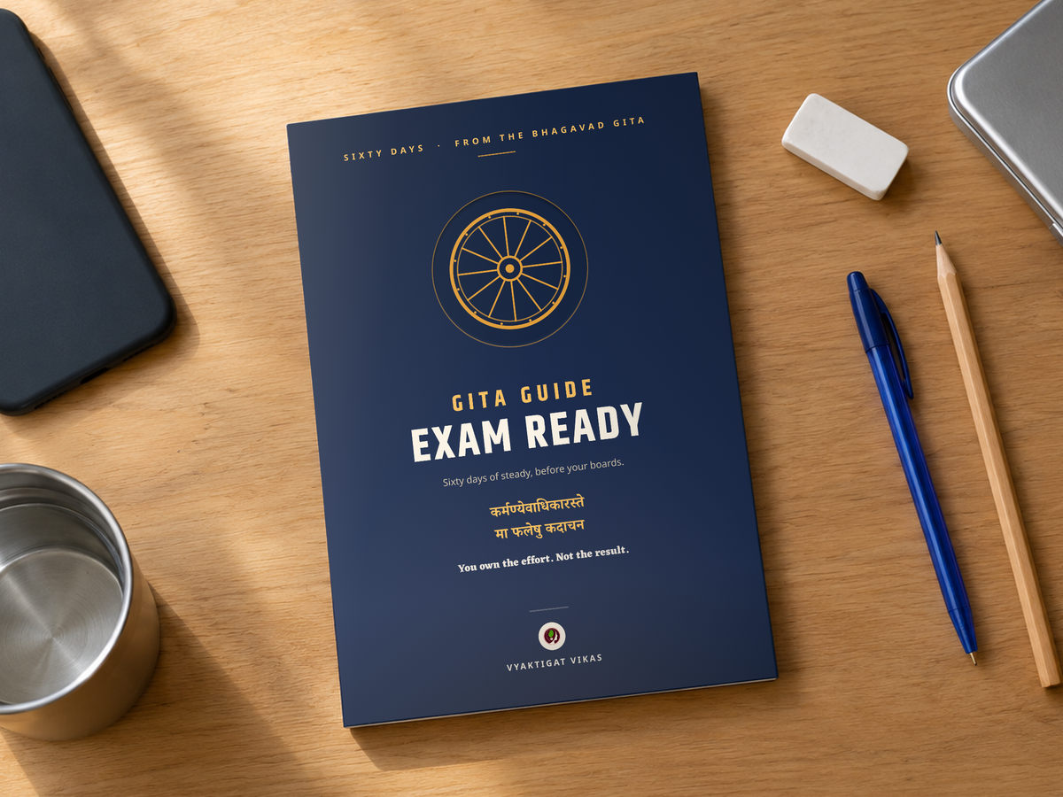 The book lying on a desk beside a phone, a pen and a pencil